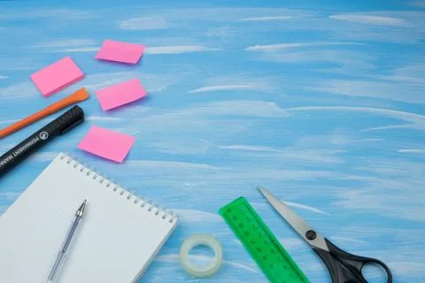 Back to school. Items for the school on a blue wooden background. Stock Photos