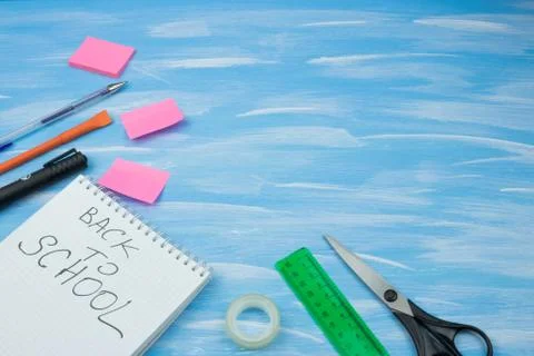 Back to school. Items for the school on a blue wooden background. Stock Photos