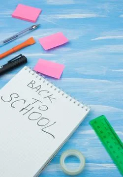 Back to school. Items for the school on a blue wooden background. Stock Photos