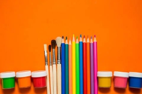 Back to school. Items for the school on a orange table. Stock Photos