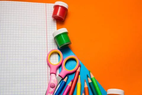 Back to school. Items for the school on a orange table. Stock Photos