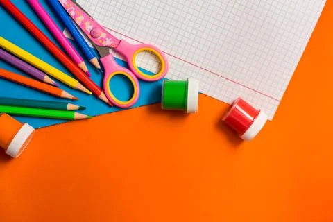 Back to school. Items for the school on a orange table. Stock Photos