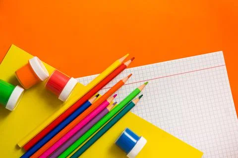 Back to school. Items for the school on a orange table. Stock Photos
