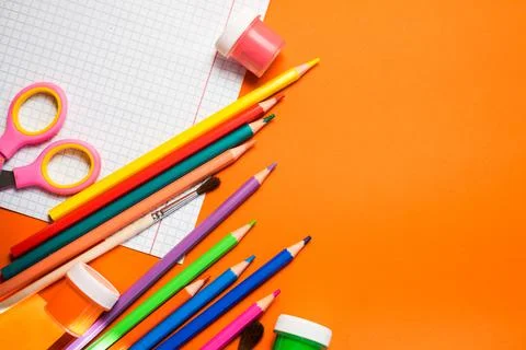 Back to school. Items for the school on a orange table. Stock Photos