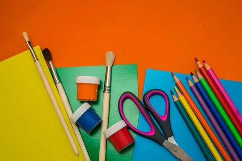 Back to school. Items for the school on a orange table. Stock Photos