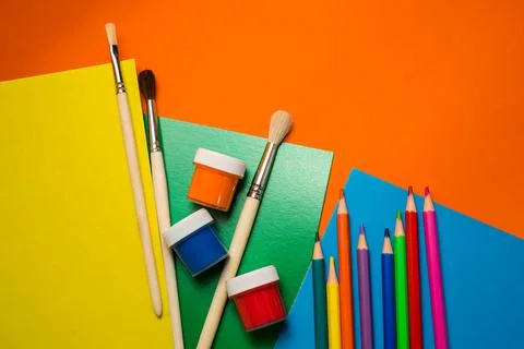 Back to school. Items for the school on a orange table. Stock Photos