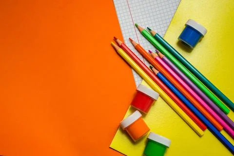 Back to school. Items for the school on a orange table. Stock Photos