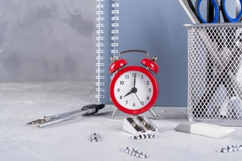 Back to school. Items for the school, red alarm clock Stock Photos