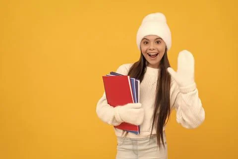 Back to school. kid with workbook on yellow background. happy childhood. 写真素材