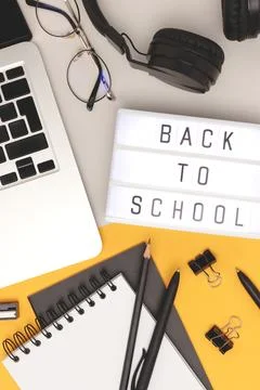 Back to school. Layout with lightbox, eyeglasses, laptop and stationery. Stock Photos