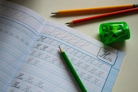 Back to school, learning to write letters correctly, notebook and pencils Stock Photos