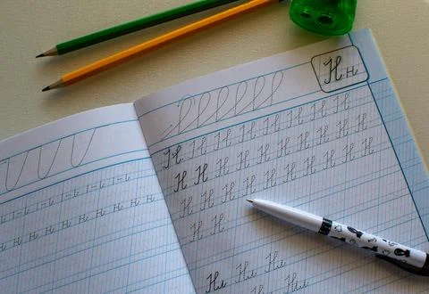 Back to school, learning to write letters correctly, notebook and pencils Stock Photos