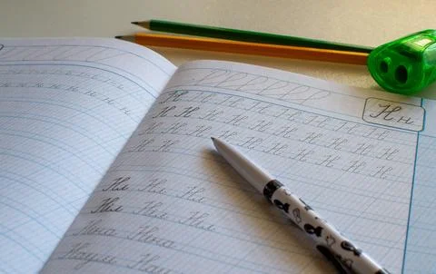 Back to school, learning to write letters correctly, notebook and pencils Foto stock