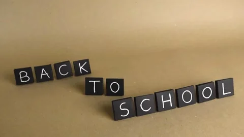 Back to school letter tiles gliding on brown paper background Stock Footage 341323119