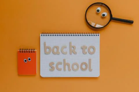 Back to school lettering on a notebook, with animated objects. Stock Photos