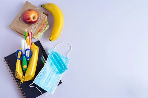 Back to School Material. Pencils, notebook and sandwich on purple background. Stock Photos
