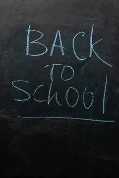 Back to School Message Written on a Chalkboard in a Classroom Setting Stock Photos