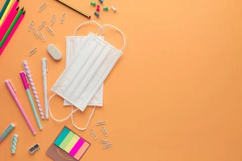 Back to school in the new normal with two face masks and some stationery Stock Photos