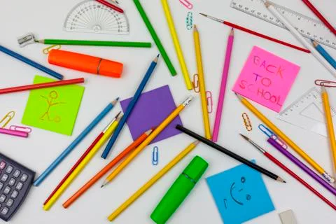 Back to school note and colouring pencils on a white desk Stock Photos