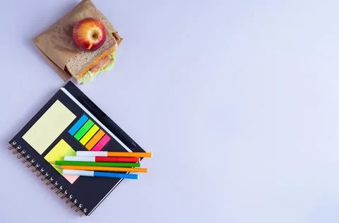 BACK TO SCHOOL with notebook, pencils and sandwich with fruit. Stock Photos