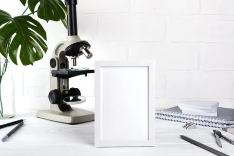 Back to school  Notebook with stationery objects and microscope on white Stock Photos