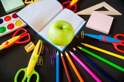 Back to school. Notepad with apple and supplies Stock Photos