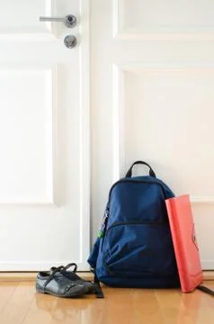 Back to school or ready for school concept with school bag and shoes by front Stock Photos