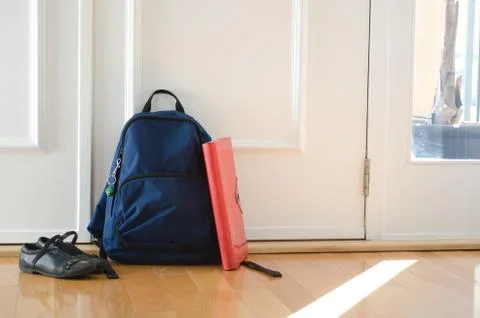 Back to school or ready for school concept with school bag and shoes by front Stock Photos
