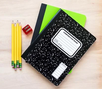 Back to school-pencils, a pencil sharpener and 2 notebooks on a wooden desk Foto stock