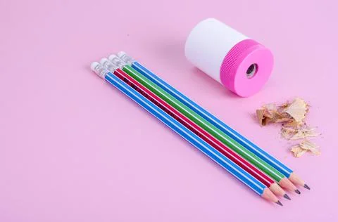Back to school. Pencils, pencil sharpener on bright pink background. Place fo Stock Photos