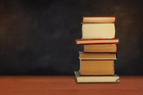 Back to school, pile of books with empty black school board background, educa Stock Photos