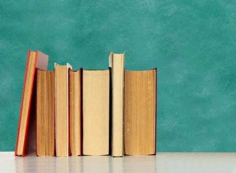 Back to school, pile of books with empty green school board background, educa Stock Photos