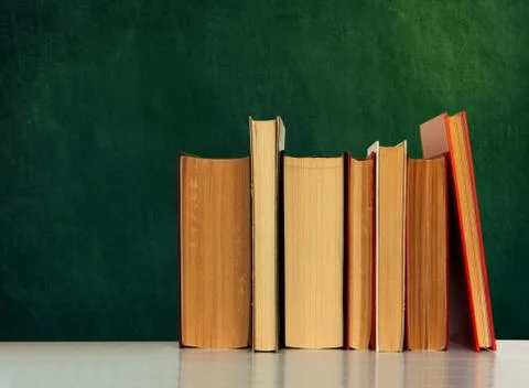 Back to school, pile of books with empty green school board background, educa Stock Photos