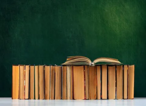 Back to school, pile of books with empty green school board background, educa Stock Photos