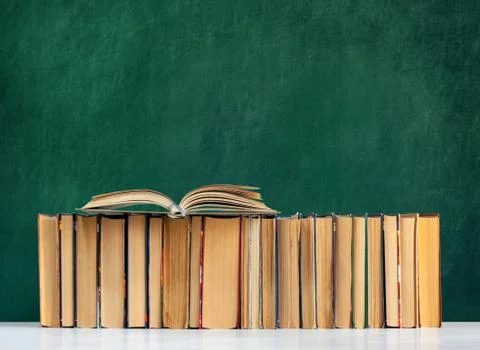 Back to school, pile of books with empty green school board background, educa Stock Photos