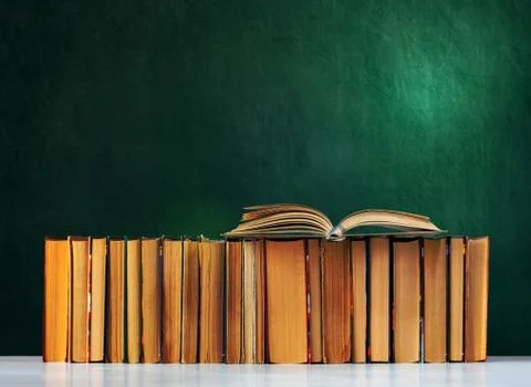 Back to school, pile of books with empty green school board background, educa Stock Photos