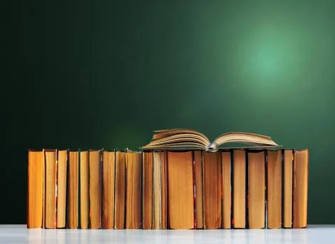 Back to school, pile of books with empty green school board background, educa Stock Photos