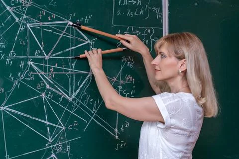 Back to school. The professor solves the problem at the blackboard Stock Photos
