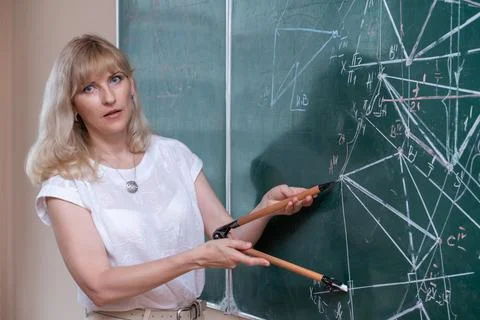 Back to school. The professor solves the problem at the blackboard Stock Photos