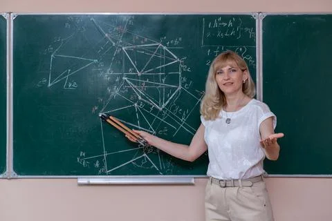 Back to school. The professor solves the problem at the blackboard Stock Photos