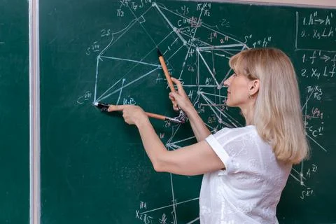 Back to school. The professor solves the problem at the blackboard Stock Photos