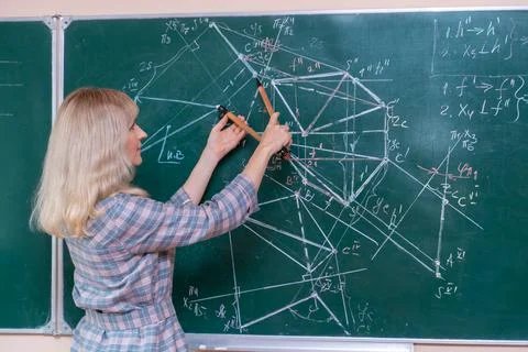 Back to school. The professor solves the problem at the blackboard Stock Photos