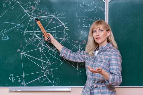 Back to school. The professor solves the problem at the blackboard Stock Photos
