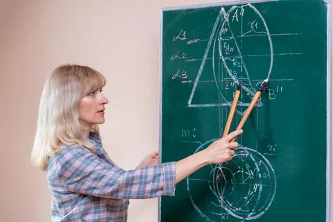 Back to school. The professor solves the problem at the blackboard Stock Photos