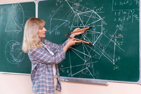 Back to school. The professor solves the problem at the blackboard Stock Photos