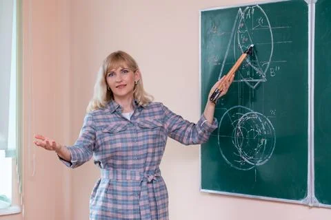 Back to school. The professor solves the problem at the blackboard Stock Photos