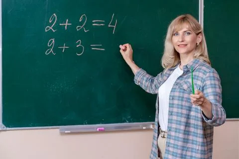 Back to school. The professor solves the problem at the blackboard Stock Photos