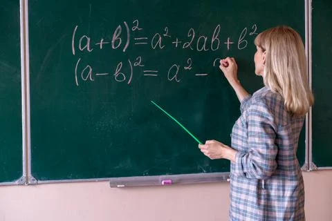 Back to school. The professor solves the problem at the blackboard Stock Photos