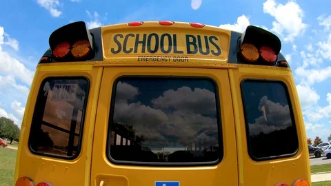 Back to School, pulling back from a school bus name and light system to Stock Footage 112638162