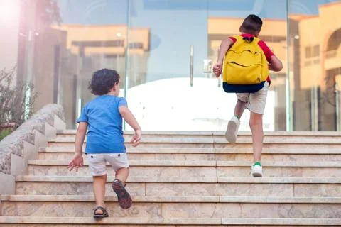 Back to school. Pupils with backpacks going to school Stock Photos